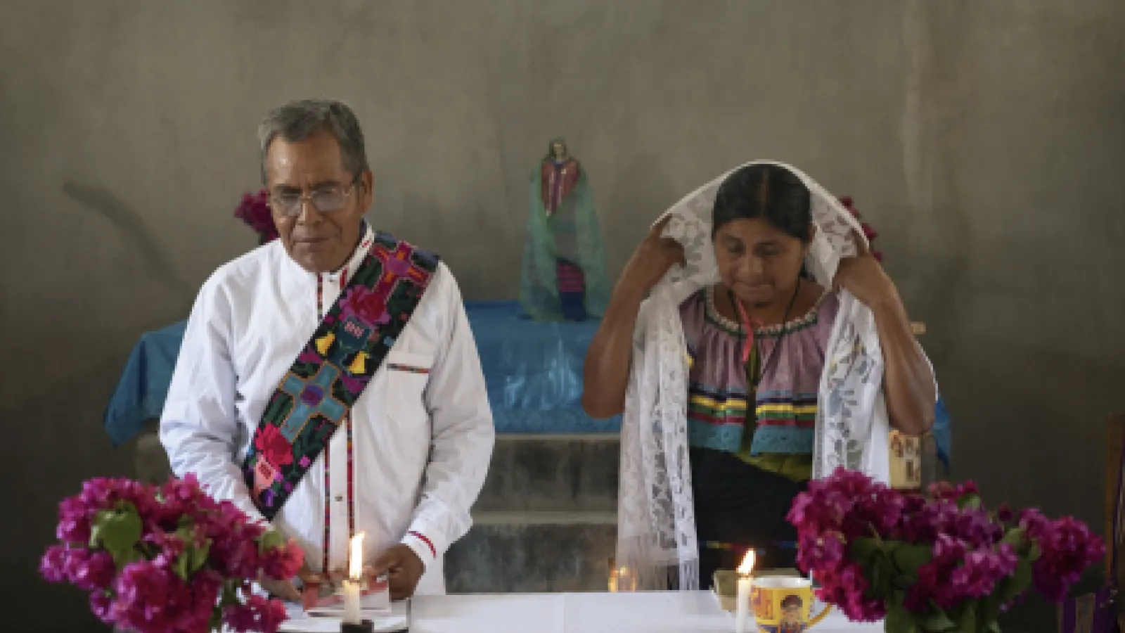 Deacon Juan Pérez Gómez, accompanied by his wife Crecencia López, stands at the altar during a Mass honouring the late Pope Francis, in Simojovel, Mexico