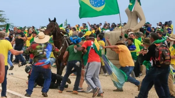 Rioters attacking a police officer (BBC)